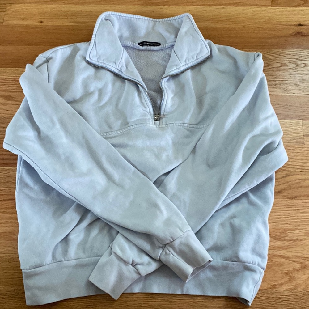 This is a baby blue half zip crewneck from Brandy Melville.